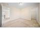 Spacious room featuring carpet, neutral walls and baseboards, a ceiling light, and several doorways at 576 Putting Dr, Fort Mill, SC 29715