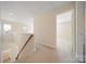 Bright hallway leading to rooms, featuring carpeted floors, white trim, and natural light at 576 Putting Dr, Fort Mill, SC 29715
