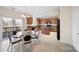 Bright kitchen with an island, wooden cabinets, stainless steel appliances, tile floor and a glass table set at 576 Putting Dr, Fort Mill, SC 29715