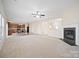 Spacious living room features a cozy fireplace and adjacent dining area at 576 Putting Dr, Fort Mill, SC 29715
