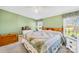 This bedroom features soothing green walls, comfortable carpeting, and a plush quilt at 590 County Line Rd, Stony Point, NC 28678