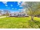 Charming house with a well-maintained lawn and inviting front porch, blending comfort and style in a picturesque country setting at 590 County Line Rd, Stony Point, NC 28678