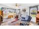 Cozy living room features a ceiling fan and comfortable armchair near bright windows at 590 County Line Rd, Stony Point, NC 28678