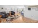Inviting living room with hardwood floors, plush seating, and an open-concept layout seamlessly connecting to dining area at 590 County Line Rd, Stony Point, NC 28678