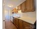 Bright kitchen with wood cabinets, stainless steel sink, and white appliances at 6132 Meadow Rose Ln, Charlotte, NC 28215