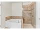 Bathroom featuring soaking tub and shower with decorative tile and glass door at 7316 Strawberry Fields Ln, Charlotte, NC 28278