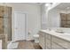 Bright bathroom featuring a double vanity, shower with glass door, and a separate toilet area at 7316 Strawberry Fields Ln, Charlotte, NC 28278