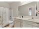Bathroom with double vanity, a shower with curtain and a mirror at 7316 Strawberry Fields Ln, Charlotte, NC 28278