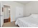 Bedroom with white bedding and a view to the bathroom at 7316 Strawberry Fields Ln, Charlotte, NC 28278