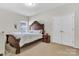 Bedroom with a bed and nightstand, a window and double doors at 7316 Strawberry Fields Ln, Charlotte, NC 28278