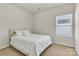 Bedroom with white bedding, and a window with blinds at 7316 Strawberry Fields Ln, Charlotte, NC 28278