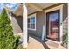 Welcoming front porch with stylish decor and a charming 'HOME' sign at 7316 Strawberry Fields Ln, Charlotte, NC 28278