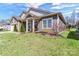 Well-maintained home with fresh landscaping, tidy lawn, and inviting front porch at 7316 Strawberry Fields Ln, Charlotte, NC 28278