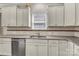 Kitchen showcasing granite countertops, a stainless steel dishwasher, and ample cabinet space at 7316 Strawberry Fields Ln, Charlotte, NC 28278