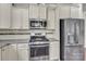 Close-up of the gourmet kitchen with stainless steel appliances and modern finishes at 7316 Strawberry Fields Ln, Charlotte, NC 28278