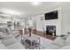 Spacious living room featuring a fireplace and an open view into the kitchen and dining area at 7316 Strawberry Fields Ln, Charlotte, NC 28278