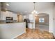 Well-lit kitchen with white cabinets, breakfast bar, and view into the living room at 8203 Gabon Ct, Charlotte, NC 28215