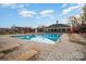 Community pool with lounge chairs, a pavilion, and clear blue water, perfect for relaxation at 8203 Gabon Ct, Charlotte, NC 28215