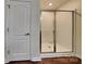 Bathroom features a glass shower stall and a white door at 8906 Paddle Oak Rd, Charlotte, NC 28227