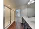 Bathroom featuring wood floor, double sink vanity and a glass shower stall at 8906 Paddle Oak Rd, Charlotte, NC 28227