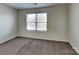 Bedroom featuring carpet, neutral walls and a window at 8906 Paddle Oak Rd, Charlotte, NC 28227