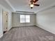 Bedroom featuring a ceiling fan, neutral walls and carpet at 8906 Paddle Oak Rd, Charlotte, NC 28227