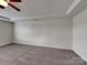 Spacious bedroom features neutral walls, carpet and ceiling fan at 8906 Paddle Oak Rd, Charlotte, NC 28227