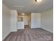 Spacious and carpeted bedroom with neutral paint, overhead lights, and hall access at 8906 Paddle Oak Rd, Charlotte, NC 28227