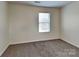 Bedroom featuring neutral walls, carpet and a window at 8906 Paddle Oak Rd, Charlotte, NC 28227