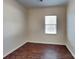 Clean bedroom with hardwood floors and a window at 8906 Paddle Oak Rd, Charlotte, NC 28227