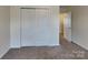 Bedroom featuring neutral walls, carpet and a sliding door closet at 8906 Paddle Oak Rd, Charlotte, NC 28227