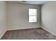 Bedroom featuring neutral walls, carpet and a window at 8906 Paddle Oak Rd, Charlotte, NC 28227