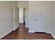 Hallway featuring hardwood floor and white doors at 8906 Paddle Oak Rd, Charlotte, NC 28227