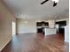 Open-concept living room and kitchen area with hardwood floors and modern appliances at 8906 Paddle Oak Rd, Charlotte, NC 28227