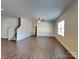 Open living room with hardwood floors and a staircase at 8906 Paddle Oak Rd, Charlotte, NC 28227