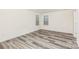 Bright bedroom with plank flooring, two windows, and neutral walls at 8915 Myra Way # 39, Charlotte, NC 28215