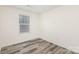This bedroom features wood-look flooring and a window with blinds at 8915 Myra Way # 39, Charlotte, NC 28215