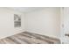 Bedroom featuring plank flooring, window, and door at 8915 Myra Way # 39, Charlotte, NC 28215