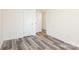 This bedroom features wood-look flooring and neutral paint at 8915 Myra Way # 39, Charlotte, NC 28215