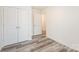 This bedroom features wood-look flooring and neutral paint at 8915 Myra Way # 39, Charlotte, NC 28215
