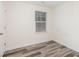 This bedroom features wood-look flooring and a window with blinds at 8915 Myra Way # 39, Charlotte, NC 28215