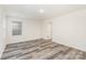 Bedroom with plank flooring, window, and access door at 8915 Myra Way # 39, Charlotte, NC 28215