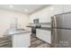 Modern kitchen featuring stainless steel appliances, granite countertops, white cabinets and hardwood-style flooring at 8915 Myra Way # 39, Charlotte, NC 28215