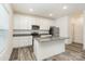 Modern kitchen with white cabinetry, stainless steel appliances, granite countertops and wood-look floors at 8915 Myra Way # 39, Charlotte, NC 28215