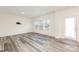Spacious living room with wood-look floors and bright, natural light with rear door and cat on wall mount at 8915 Myra Way # 39, Charlotte, NC 28215