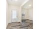 A bright, open living room with neutral walls and wood-look flooring and a white front door at 8915 Myra Way # 39, Charlotte, NC 28215