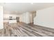 Spacious open-concept living room and kitchen with hardwood floors and modern white kitchen cabinetry at 8915 Myra Way # 39, Charlotte, NC 28215