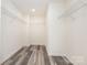 Walk-in closet featuring plank flooring and wire shelving at 8915 Myra Way # 39, Charlotte, NC 28215