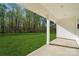 Covered back porch offers a serene view of the expansive backyard and surrounding trees at 902 Westminster Dr, Statesville, NC 28677