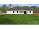 Well-manicured backyard featuring green grass and exterior of home at 902 Westminster Dr, Statesville, NC 28677